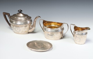 A George III Scottish silver 4 piece oval tea set with gilt interiors comprising teapot with ebony mounts, sugar bowl, milk jug and teapot stand Edinburgh 1802, maker W and P Cunningham, gross weight 1070 grams 