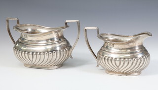 An Edwardian demi fluted silver cream jug and sugar bowl, Birmingham 1902, 273 grams 