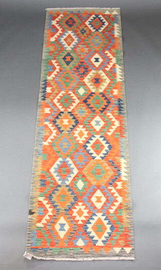 A yellow, green and brown ground Chobi Kilim runner with geometric designs 284cm x 86cm  
