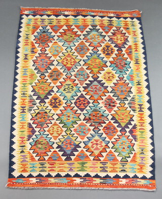 A turquoise, white and yellow ground Chobi Kilim rug with all over geometric designs 157cm x 107cm 