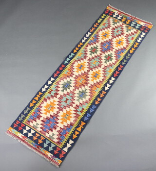 A white, brown and yellow ground Chobi Kilim runner with over all geometric designs 200cm x 63cm 