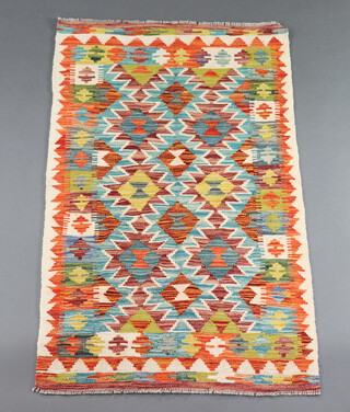 A white, brown, green and orange ground Chobi Kilim rug 127cm x 78cm 