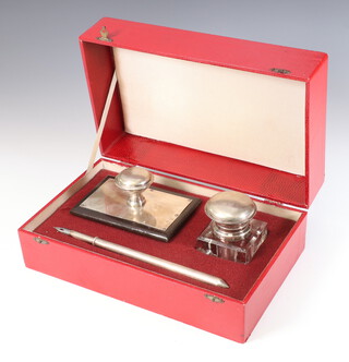 A silver plated mounted desk set comprising blotter, inkwell and pen, contained in a fitted box 