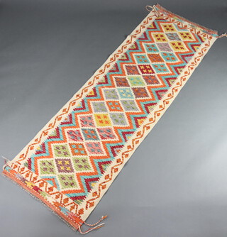 A white, green and yellow ground Chobi, Kilim runner with all over diamond design 244cm x 76cm 