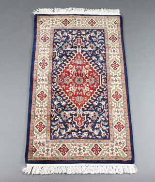 A blue and floral ground Persian rug 138cm x 78cm 
