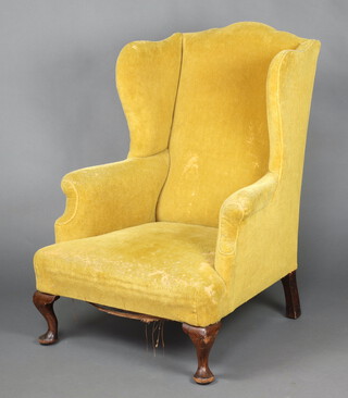 A Georgian style winged armchair upholstered in yellow material, raised on cabriole supports 108cm h x 80cm w x 70cm d 