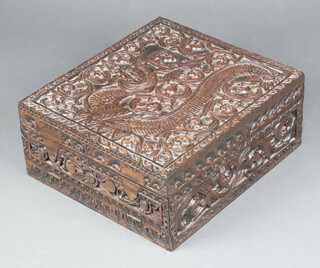 A 19th Century rectangular deeply carved camphor box with hinged lid and fall front, the interior fitted 2 shallow trays 20cm h x 43cm w x 48cm d 