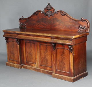 A Victorian carved mahogany sideboard with carved shaped back, the base fitted 3 drawers above double cupboard enclosed by panelled doors flanked by cupboards 160cm h x 213cm w x 60cm d