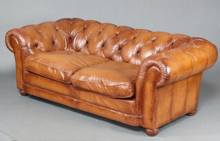 A 2 seat Chesterfield upholstered in brown buttoned leather 66cm h x 185cm w x 84cm d (seat 127cm w x 43cm d) 