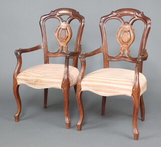 A pair of 19th Century Dutch mahogany slat back open arm chairs, the seats of serpentine outline upholstered in Regency striped material, raised on cabriole supports 102cm h x 54cm w x 45cm d 