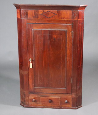 A 19th Century mahogany corner cabinet with moulded cornice fitted shelves enclosed by a panelled door, the base fitted 1 long and 2 dummy drawers 131cm h x 85cm w x 60cm d 