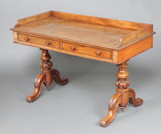 A Victorian bleached mahogany washstand/writing table with 3/4 gallery, fitted 2 drawers, raised on turned supports with H framed stretcher 81cm h x 121cm w x 57cm d  