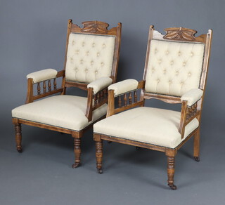 A pair of Victorian carved walnut open arm chairs upholstered in light buttoned material and bobbin turned decoration, raised on turned supports 102cm h x 68cm w x 64cm d  