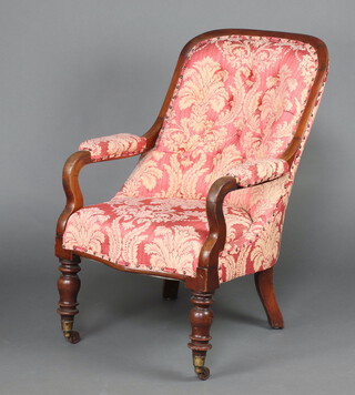 A Victorian mahogany show frame open arm chair upholstered pink floral buttoned material, raised on turned supports 89cm h x 58cm w x 52cm d 