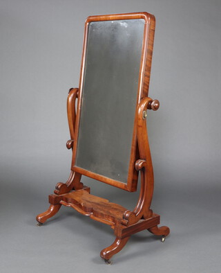 A Victorian arched plate cheval mirror contained in a mahogany swing frame, the base of serpentine outline 159cm h x 82cm w x 61cm d 