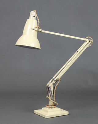 A cream painted anglepoise table lamp on a square base 