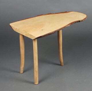 A rustic elm table, the top formed form a sliced section of tree, on outswept supports 45cm h x 64cm w x 34cm d 
