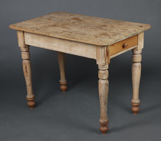 A Victorian rectangular pine table fitted a frieze drawer raised on turned supports 56cm h x 104cm l x 63cm w (top is warped, stained in places) 
