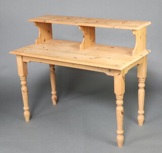 A rectangular pine computer table the top with raised superstructure, on turned supports 101cm h x 118cm w x 61cm d (water and contact marks in places) 
