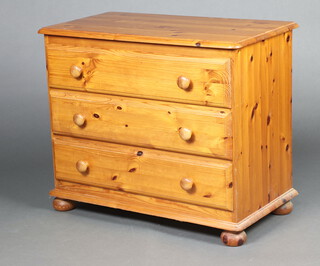 A pine chest of 3 drawers, raised on bun feet 69cm h x 80cm w x 43cm d 