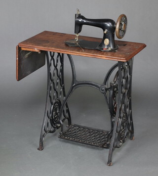 A Singer treadle operated sewing machine on an iron base 73cm h x 76cm w x 41cm d 