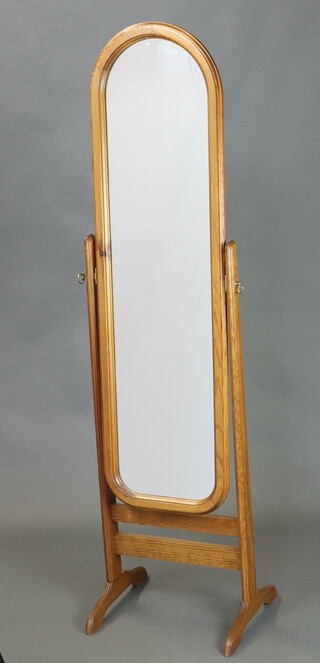 An arched plated cheval mirror contained in a pine swing frame 155cm h x 41cm w 