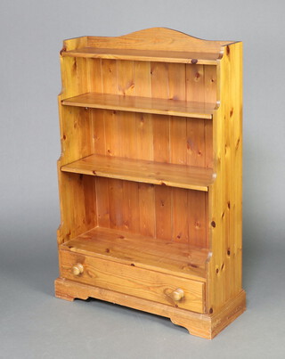 A 3 tier pine waterfall bookcase with raised back, the base fitted a drawer 124cm h x 80cm w x 27cm d  