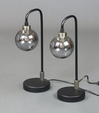A pair of mid-century style tubular metal and glass table lamps