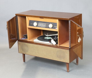 A Bush Type SRG 110 radiogram contained in a walnut finished case complete with instructions 73cm h x 83cm w x 37cm d 