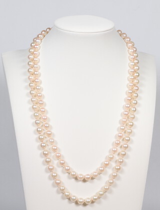 A strand of cultured pearls, each 5mm, having a yellow metal 750 diamond set clasp, 94cm 