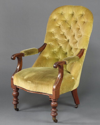 A William IV mahogany show frame armchair upholstered in green buttoned material, raised on turned supports 102cm h x 61cm w x 58cm d 