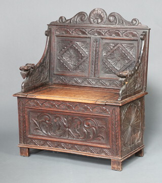 A Victorian carved oak settle with raised back, the base with hinged lid, on square supports 108cm h x 90cm w x 46cm d