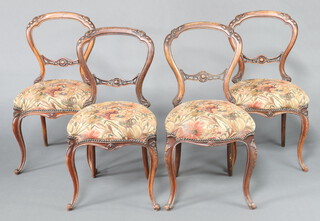 A set of 4 Victorian carved rosewood balloon back dining chairs with overstuffed seats and carved mid rails 89cm h x 47cm w x 44cm d 