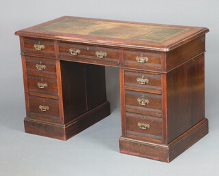 A Victorian mahogany kneehole desk with green leather inset writing surface, 1 long and 8 short drawers, raised on a platform base 80cm h x 124cm w x 62cm d