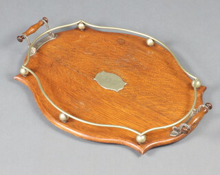 An oval oak twin handled tea tray with silver plated gallery 58cm x 41cm 