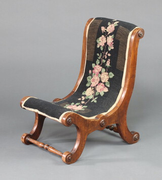 A Victorian mahogany show frame slipper nursing chair, upholstered in Berlin woolwork material, on scroll supports 60cm h x 41cm w x 50cm d 