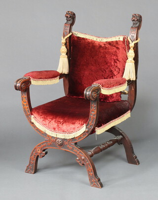 A Roman style carved walnut open armchair, raised on X framed supports 106cm h x 65cm w x 53cm d 