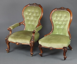 A Victorian carved walnut open arm chair upholstered in green material 69cm h  together with a matching nursing chair 88cm h 