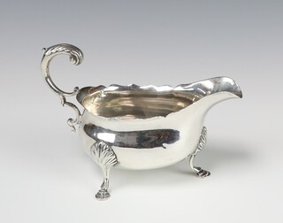 A George III silver sauce boat with S scroll handle, shell knees and hoof feet, London 1773, 119 grams 