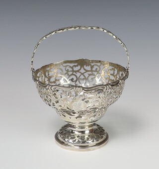 A pierced silver swing handled circular basket with engraved armorial London 1913, 198 grams, 12cm 