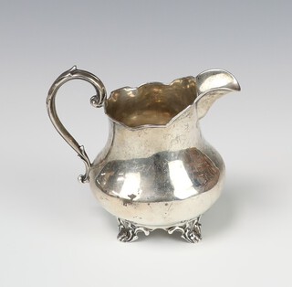 A Victorian silver cream jug on scroll feet London 1851, 124 grams