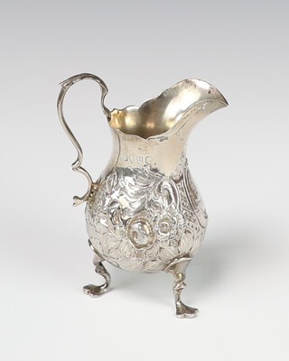 A Victorian repousse silver cream jug with vacant cartouche, London 1887, 63 grams 