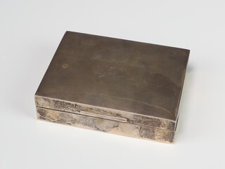 A rectangular silver cigarette box with engraved inscription Sheffield 1935 