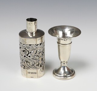 A Victorian pierced silver bottle holder London 1900, 96 grams, 11.5cm and a silver tapered vase (weighted) 9cm  