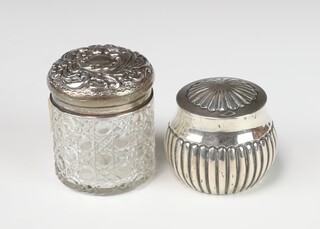 A Victorian repousse silver demi fluted box and cover Birmingham 1890 together with a silver mounted toilet jar, weighable silver 59 grams 