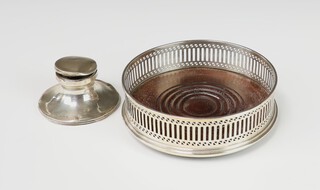 An Edwardian silver capstan inkwell Birmingham 1910 (dented) and a pierced silver coaster London 1979