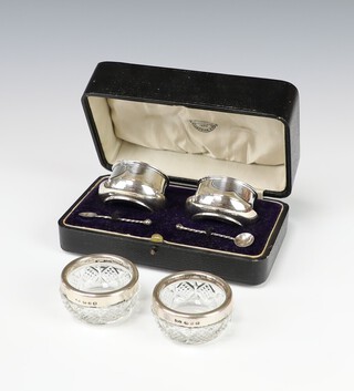 A pair of silver table salts with blue glass liners, Birmingham 1912, together with a pair of silver mounted cut glass ditto 37 grams 