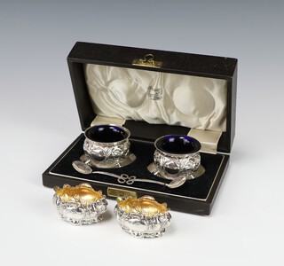 A pair of silver table salts with repousse decoration Sheffield 1901 together with a pair of plated ditto cased 