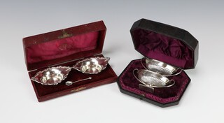 A pair of Adam style silver table salts with demi-fluted decoration Sheffield 1911, a pair of boat shaped ditto with spoons Sheffield 1909, both case, 100 grams 