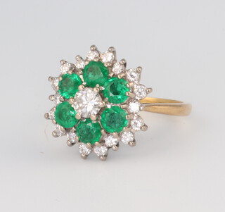 An 18ct yellow gold emerald and diamond cluster ring, the 6 brilliant cut emeralds each approx. 0.3ct, the 18 brilliant cut diamonds each approx. 0.03ct, the centre brilliant cut diamond approx. 0.3ct, gross weight 6.4 grams, size O 1/2